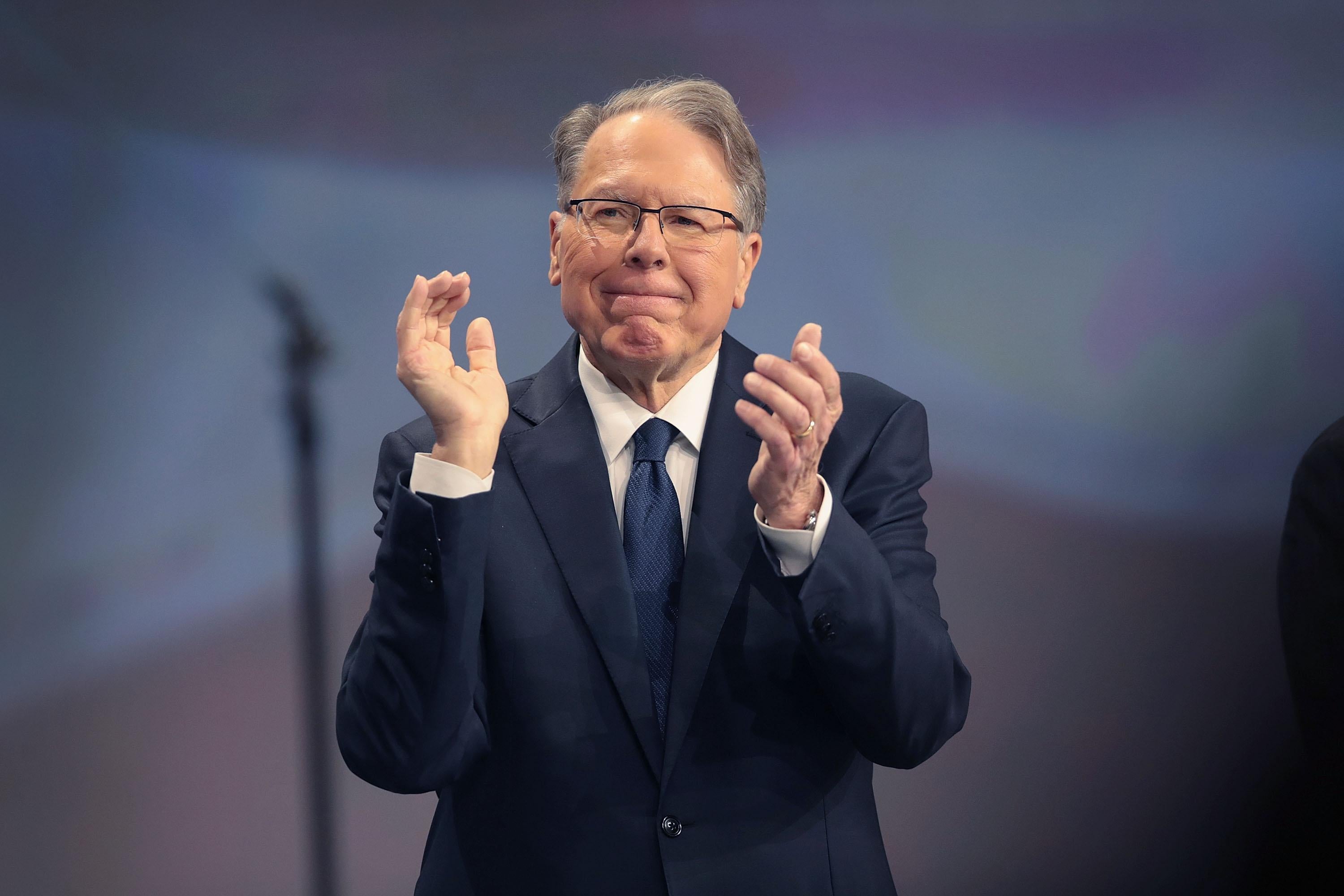 NRA CEO Wayne LaPierre claps at an NRA event.