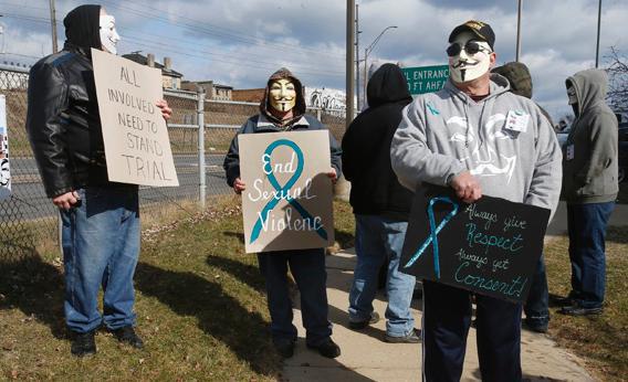 A group of protesters stand outside juvenile court in Steubenville, Ohio, March 14, 2013.