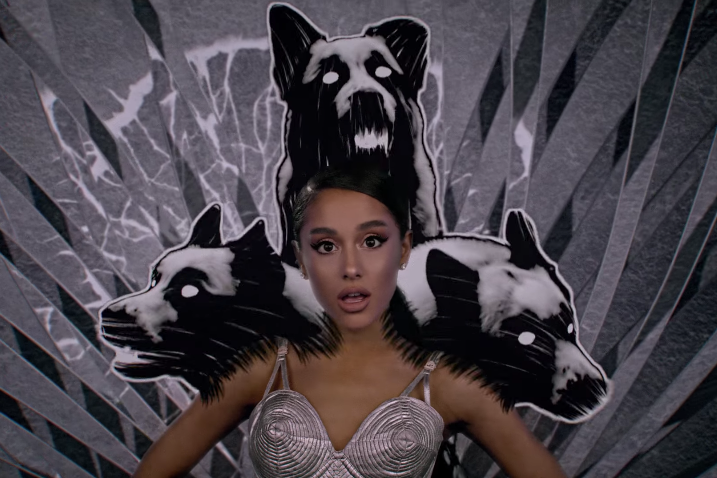 Ariana Grande in a cone bra, as the fourth head of a three-headed dog.