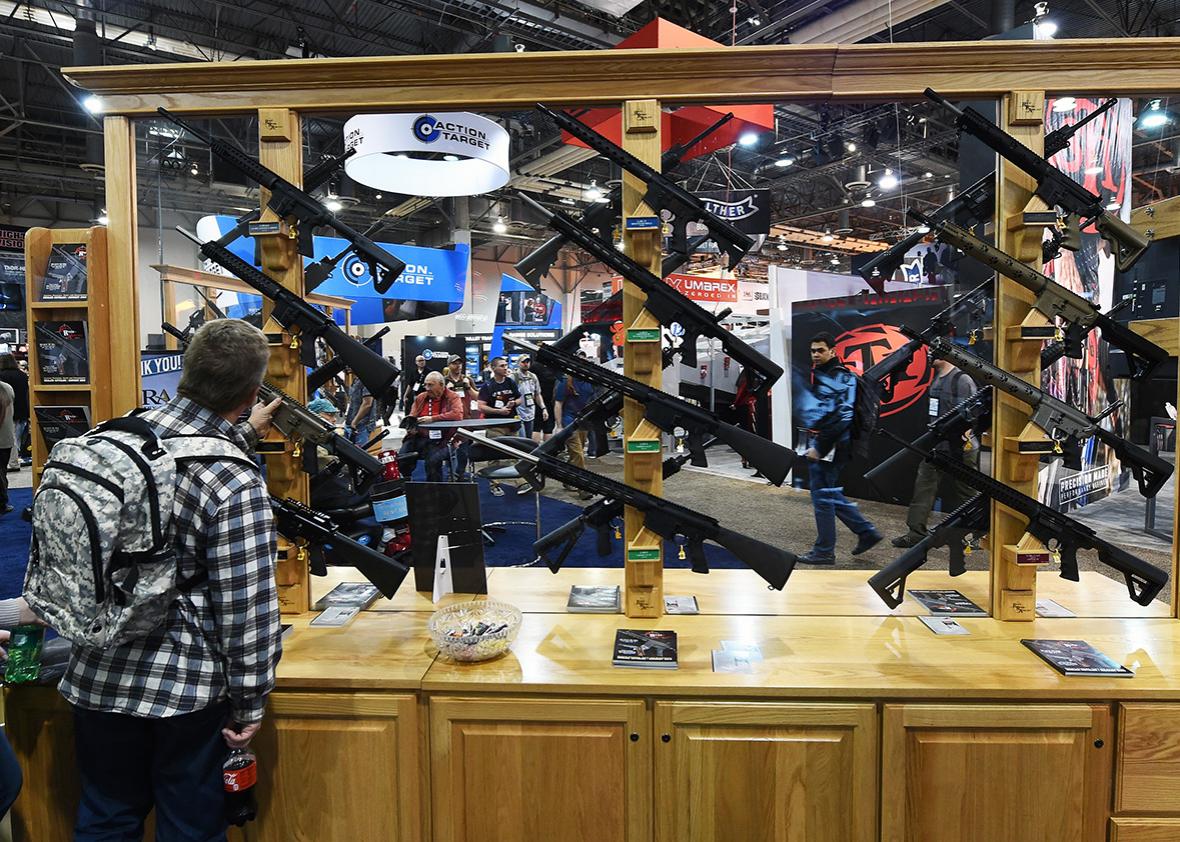A convention attendee looks at rifles displayed at the Rock River Arms booth at the 2016 National Shooting Sports Foundation's Shooting, Hunting, Outdoor Trade Show at the Sands Expo and Convention Center on January 19, 2016 in Las Vegas, Nevada. 