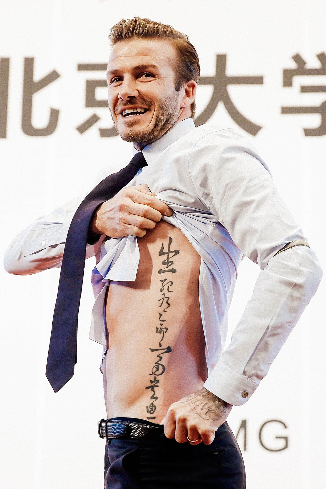 David Beckham shows off a Chinese language tattoo along his torso.