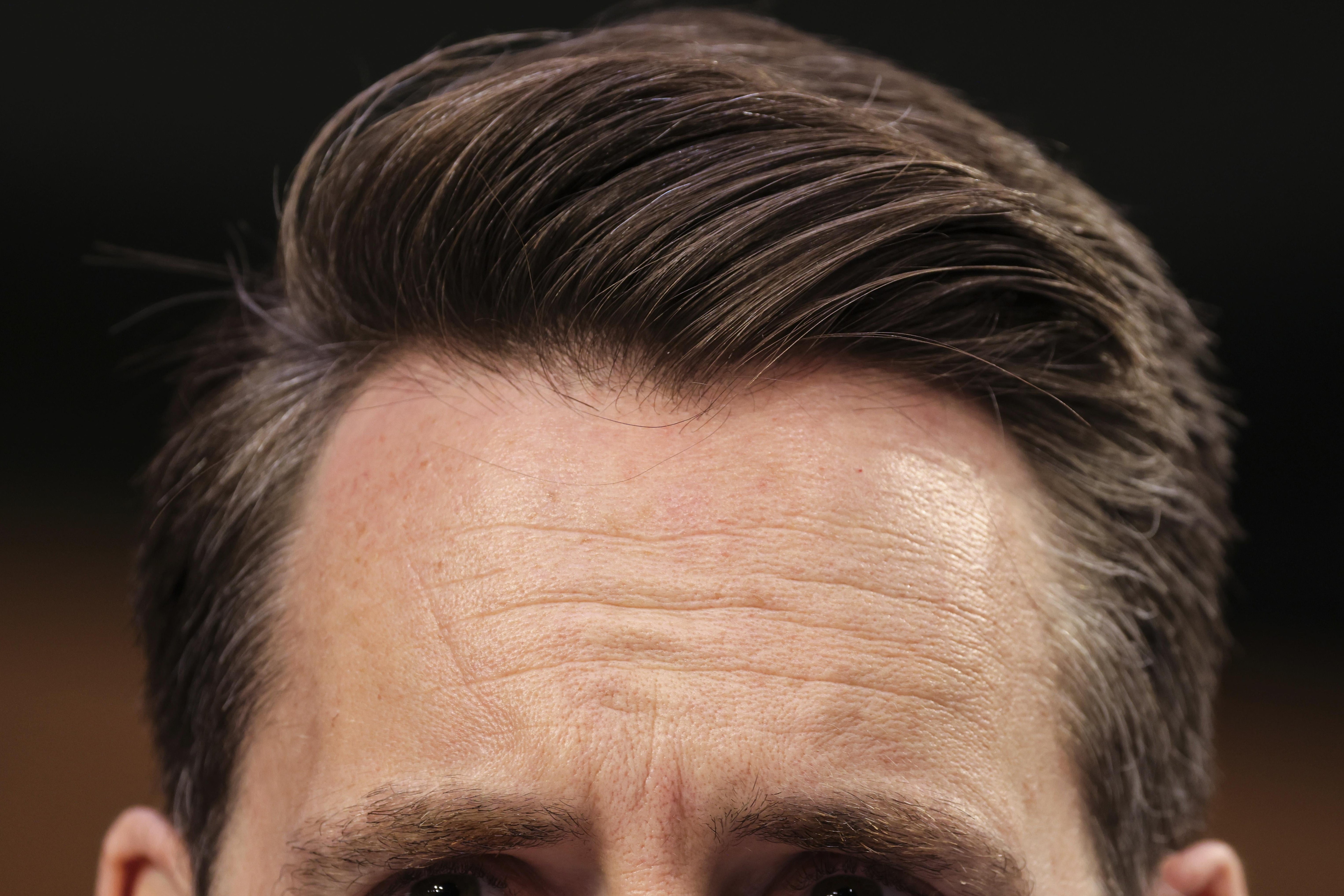 An extreme close up of Josh Hawley's eyes and well-coiffed hair.