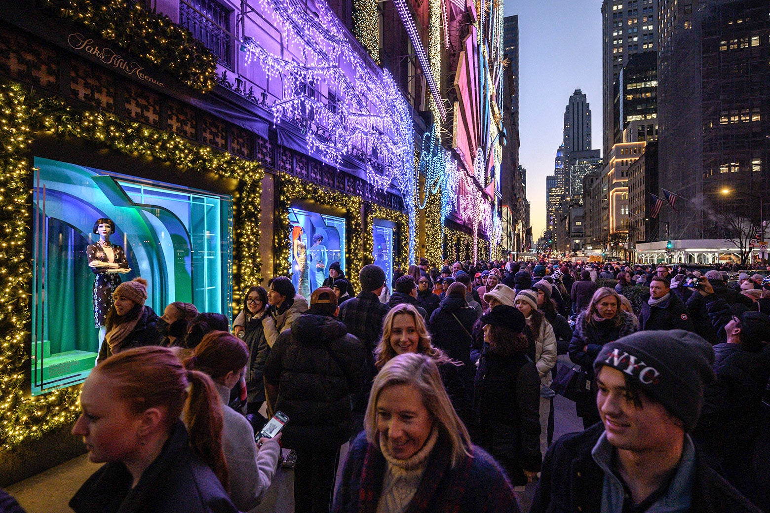 Shoppers and tourists walk by Saks Fifth Avenue in New York