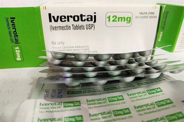 Blister packets of pills in front of a box that says Iverotaj.