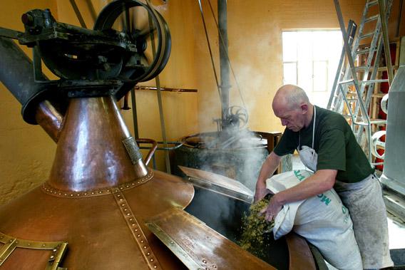 Belgian 61-year-old master-brewer Jean-Pierre Van Roy adds hops to a brew kettle at the traditional Cantillon brewery in Brussels.