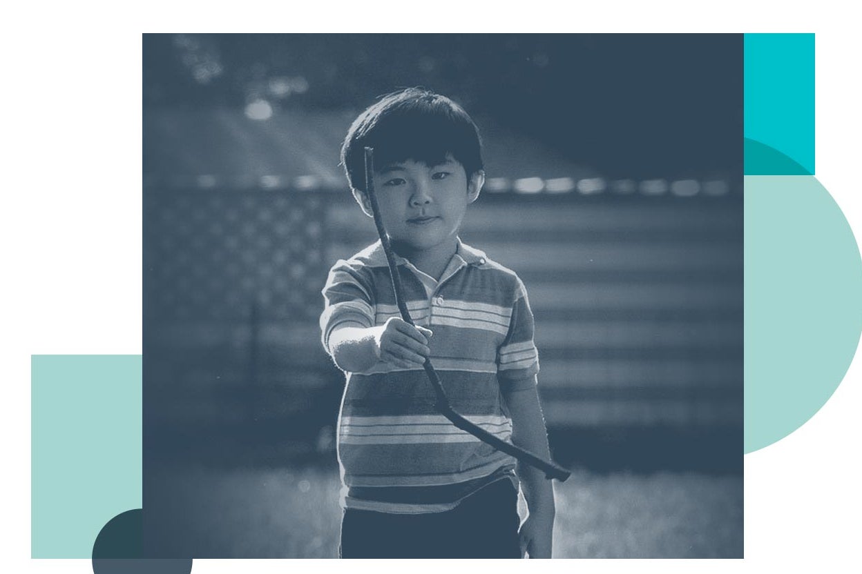 A young boy holding a dowsing rod, from Minari.