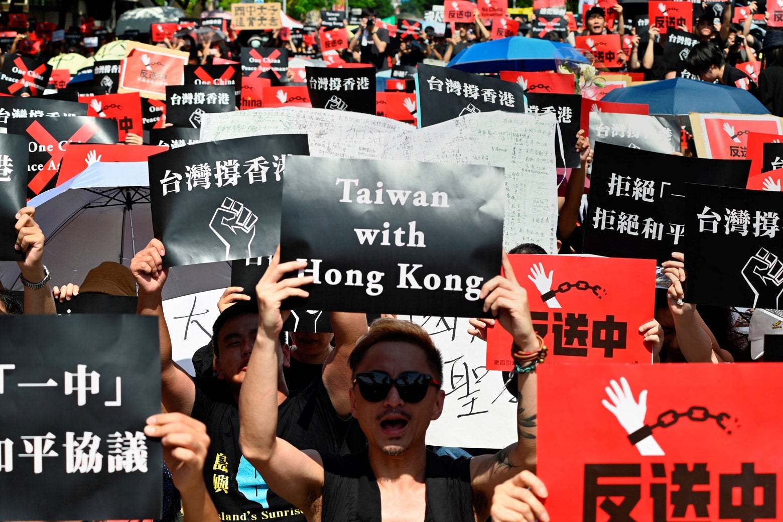 Protesters display placards during a demonstration in Taipei on Sunday in support of the continuing protests taking place in Hong Kong.