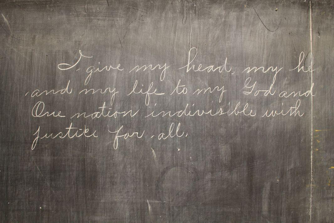 School Written on Vintage Chalkboard and a Chalk on the Board