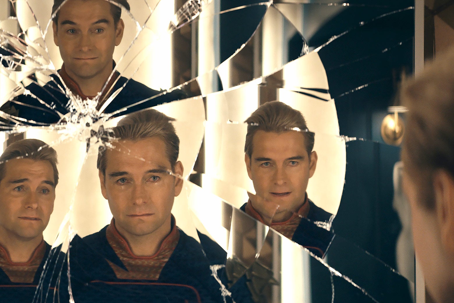 A fractured mirror showing many reflections of Homelander.