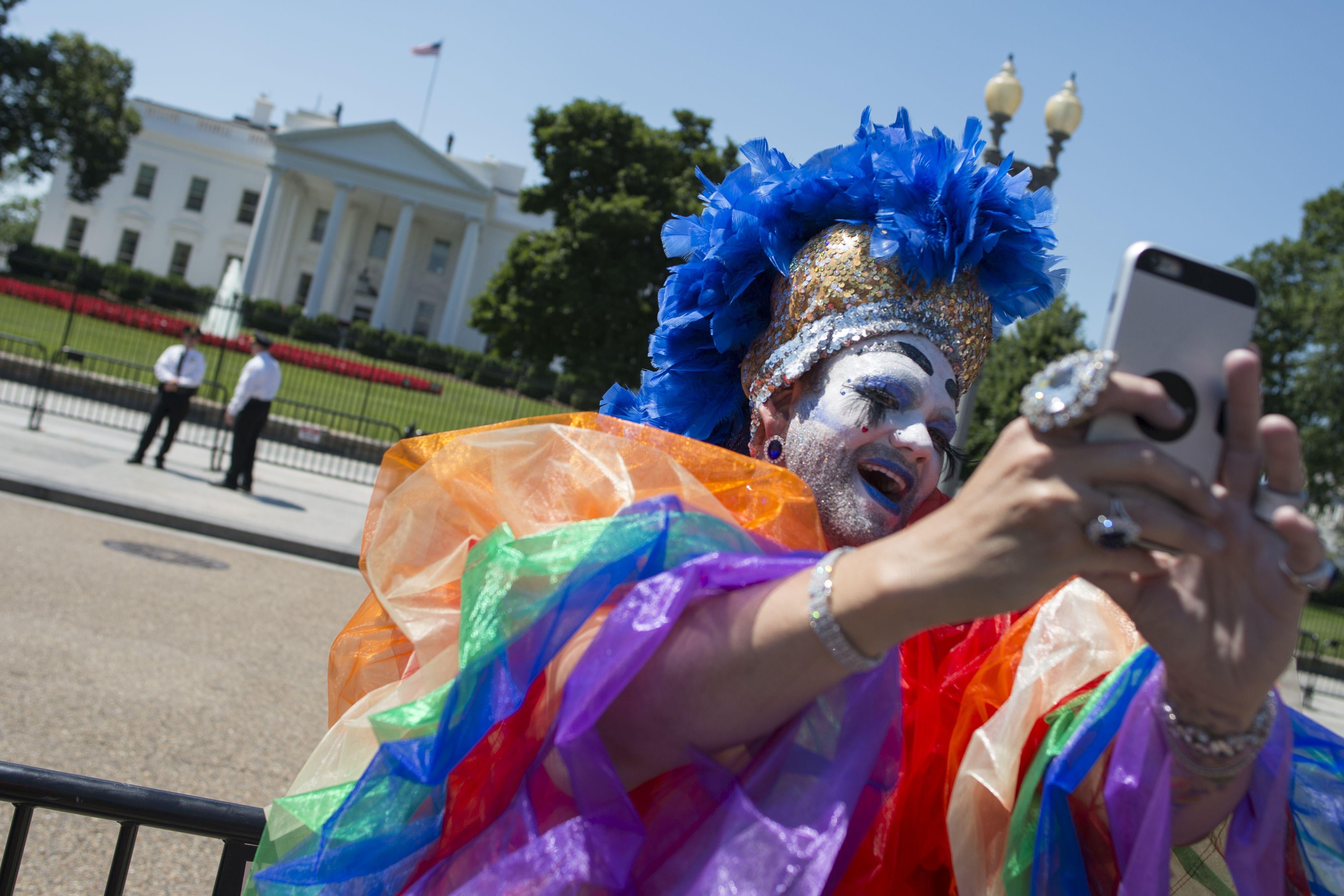 A Drag Queen takes a photo as LGBT members and their supporters walk past the White House during the Equality March for Unity & Pride parade in Washington DC, June 11, 2017. / AFP PHOTO / Andrew CABALLERO-REYNOLDS        (Photo credit should read ANDREW CABALLERO-REYNOLDS/AFP/Getty Images)