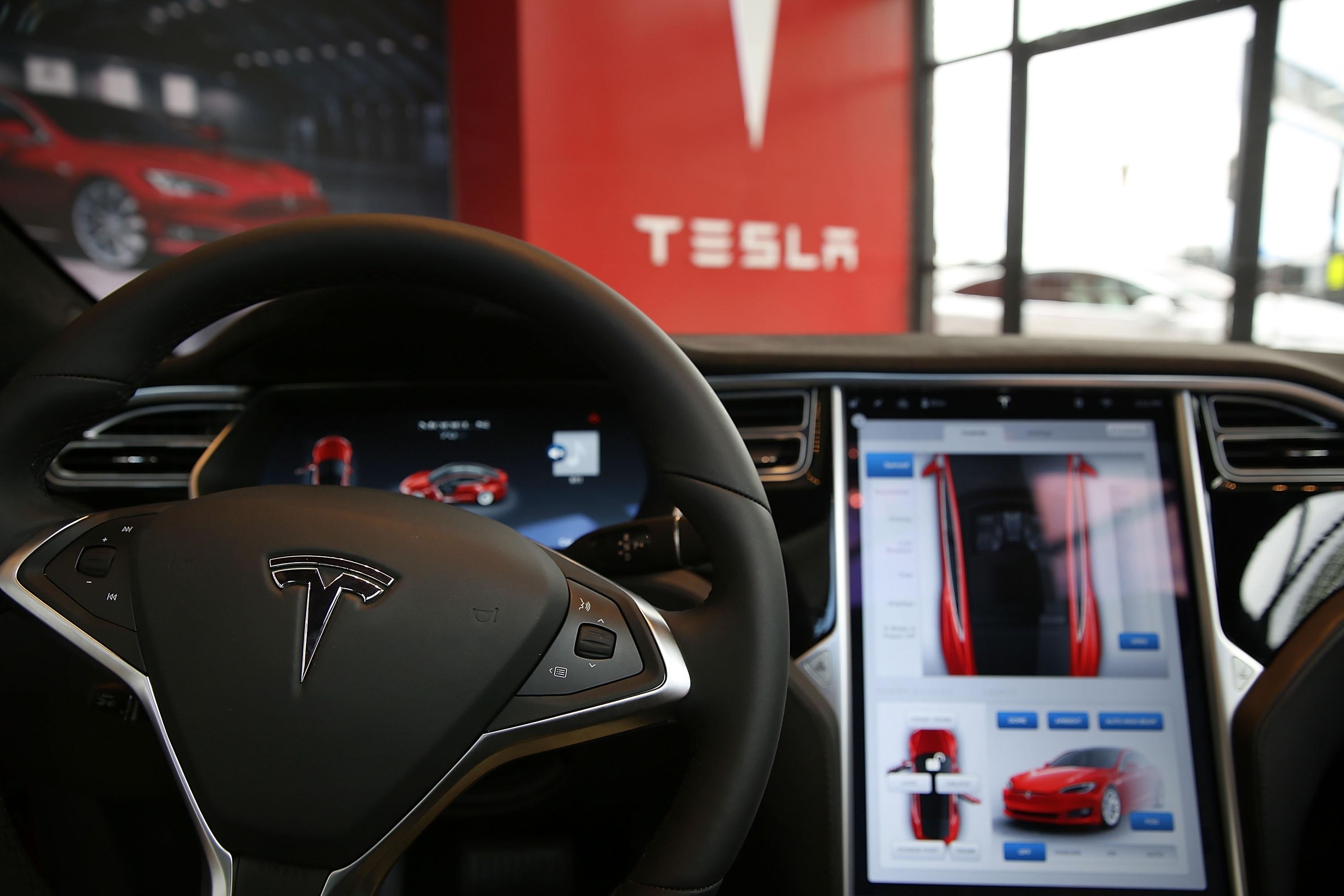 The inside of a Tesla vehicle as it sits parked in a new Tesla showroom.