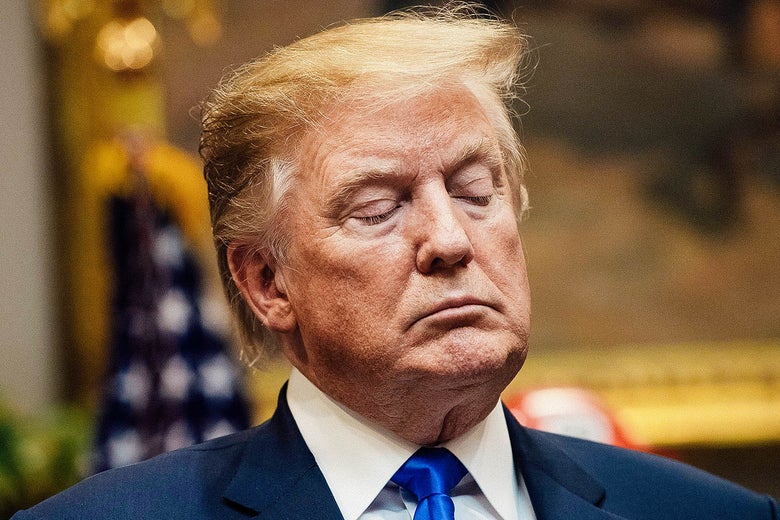 Donald Trump with his eyes lowered.