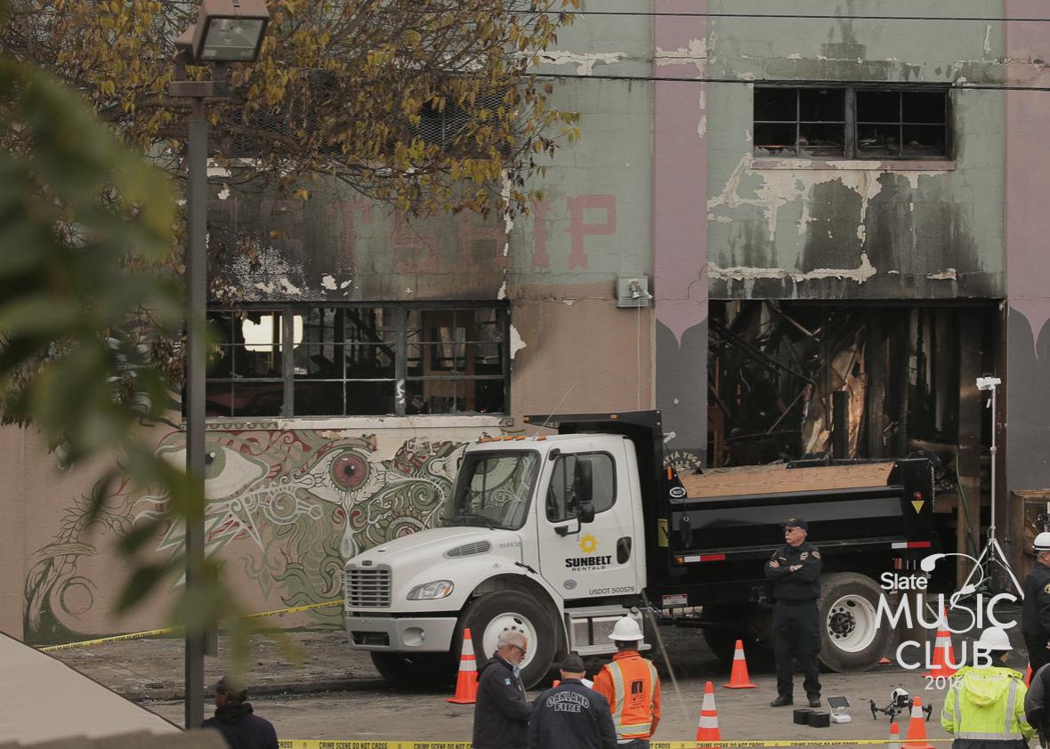 Law enforcement and firefighters are seen at the site of a warehouse fire that has claimed the lives of at least thirty-six people on December 5, 2016 in Oakland, California. 