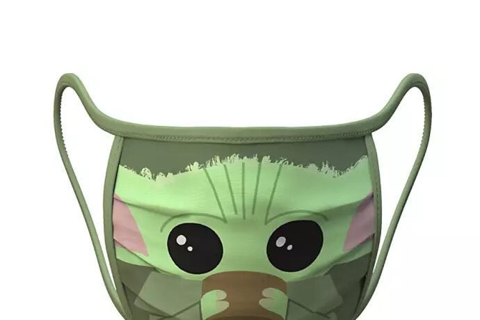 A face mask featuring a cartoonish picture of Baby Yoda drinking from a cup.