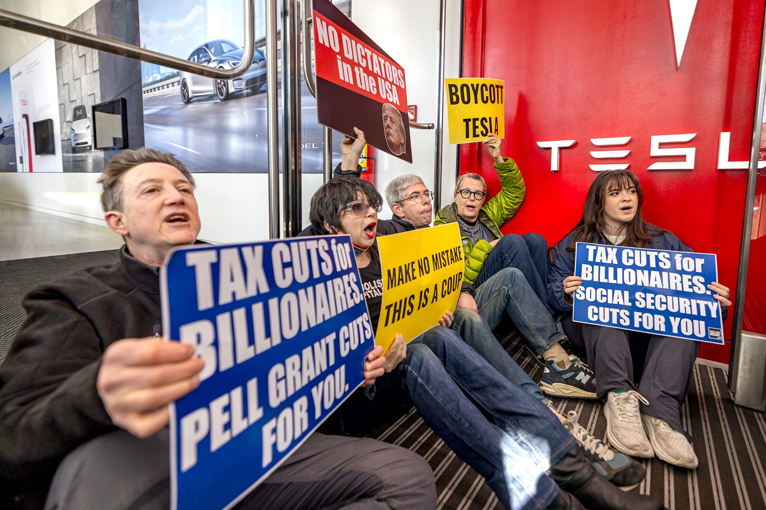 Protesters block an entrance to a Tesla showroom during a protest on the westside of Manhattan on March 1 in New York City. 