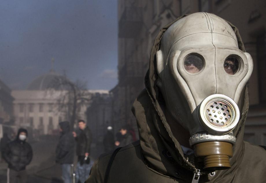 A protester wears a gas mask during clashes with Interior Ministry members in Kiev on Feb. 18, 2014. UKRAINE/