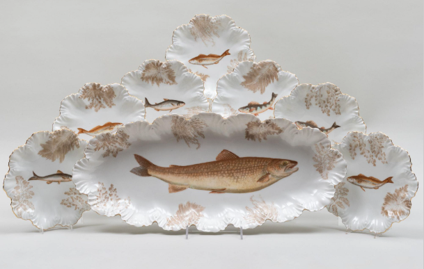 China dishes with fish on them.