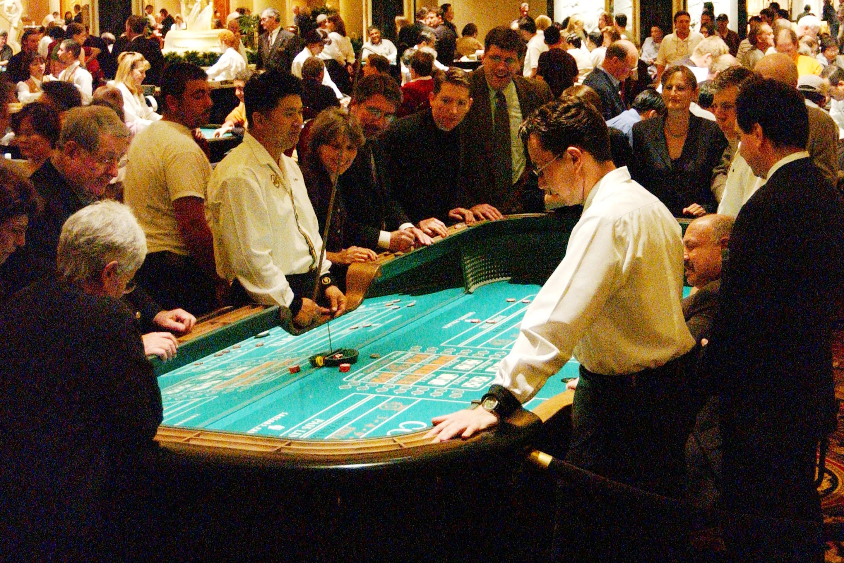 Gamblers play craps at a casino in Vegas