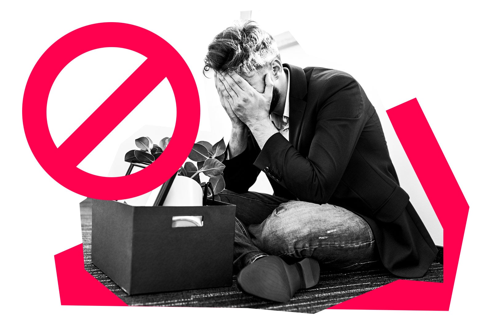 Man sitting on the ground with his head in his hands behind a box of his office possessions. 