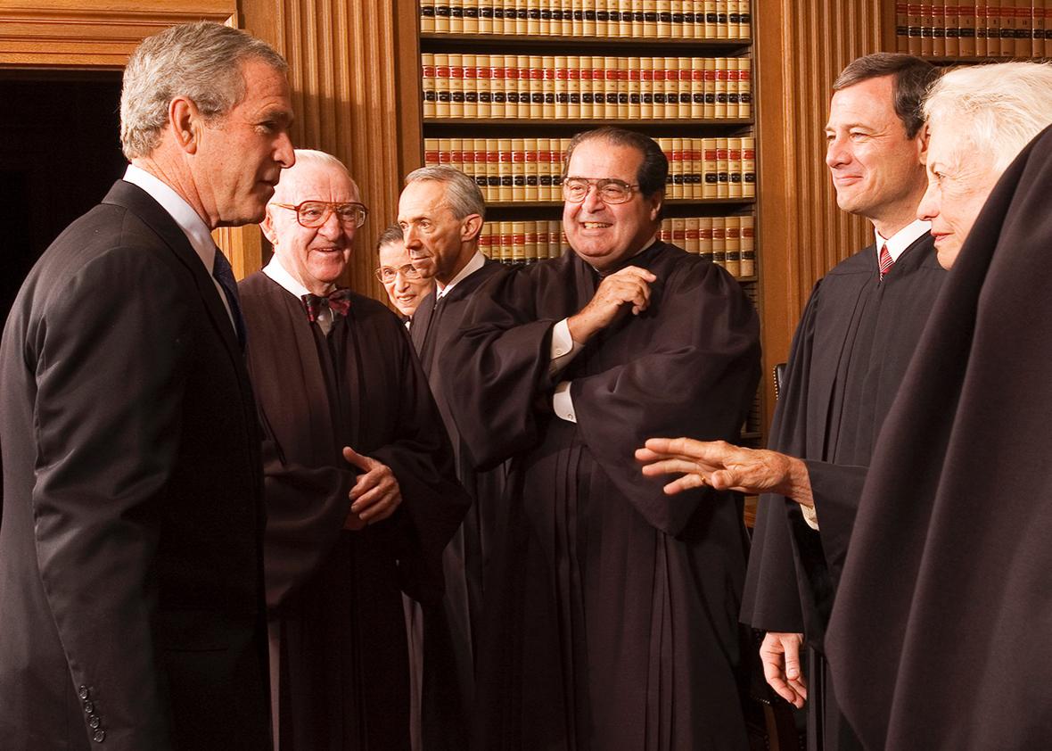 President George W. Bush enjoys a light moment with members of the Supreme Court, Oct. 3, 2005.