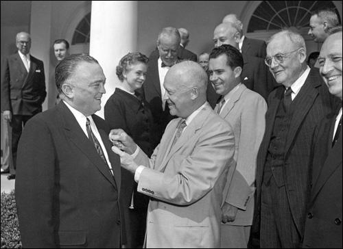 Director Hoover receives the National Security Medal from President Dwight Eisenhower on May 27, 1955, as then-Vice President Richard Nixon and others look on. 