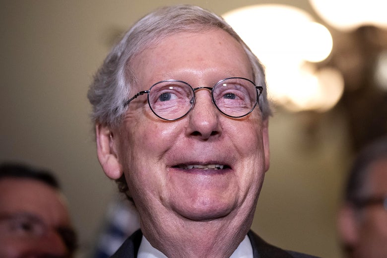 Mitch McConnell grins.