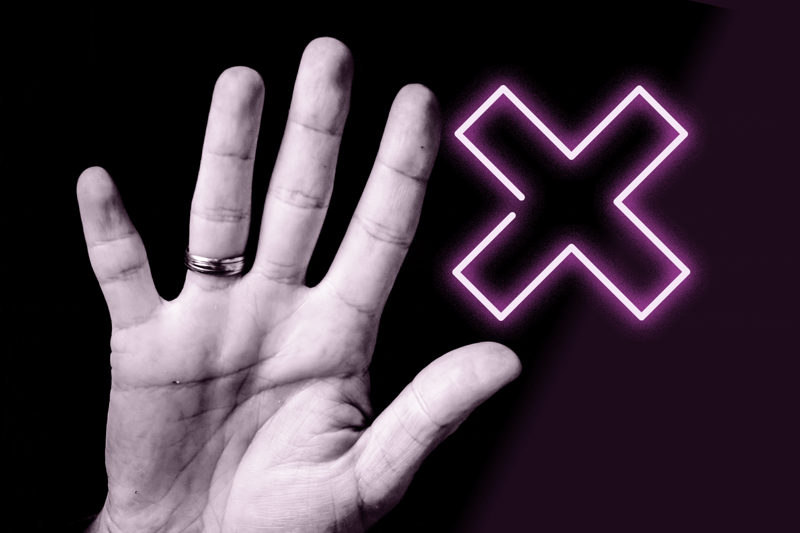 A hand raised next to a neon X sign.