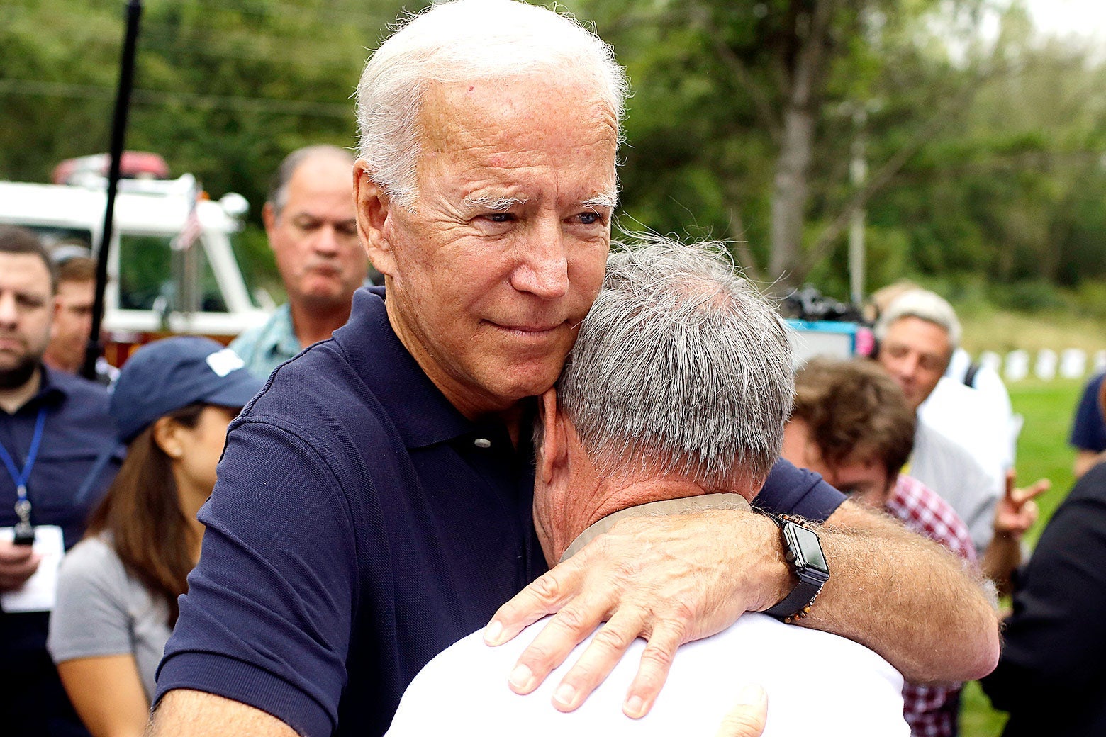 Biden hugging an older man in front of a crowd of supporters