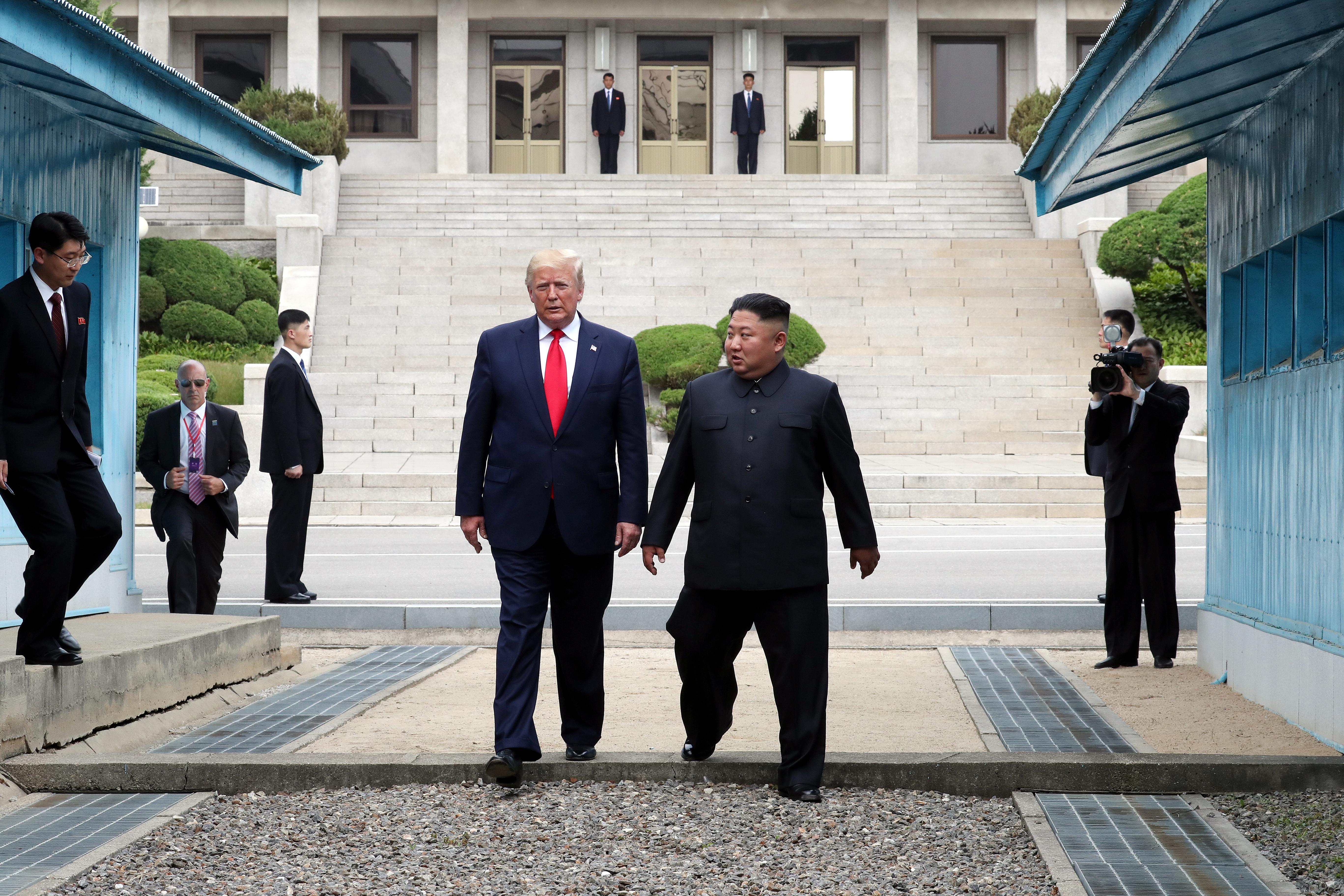 North Korean leader Kim Jong-un and U.S. President Donald Trump walk inside the demilitarized zone separating South and North Korea.