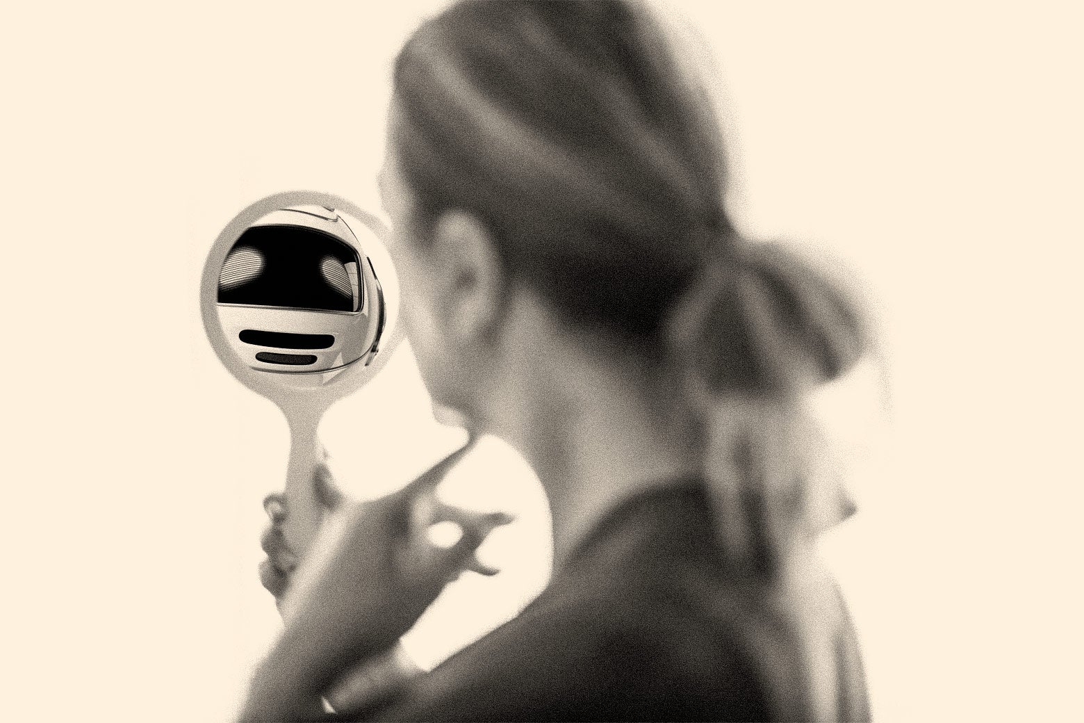A woman holds up a hand mirror and a robot looks back at her.