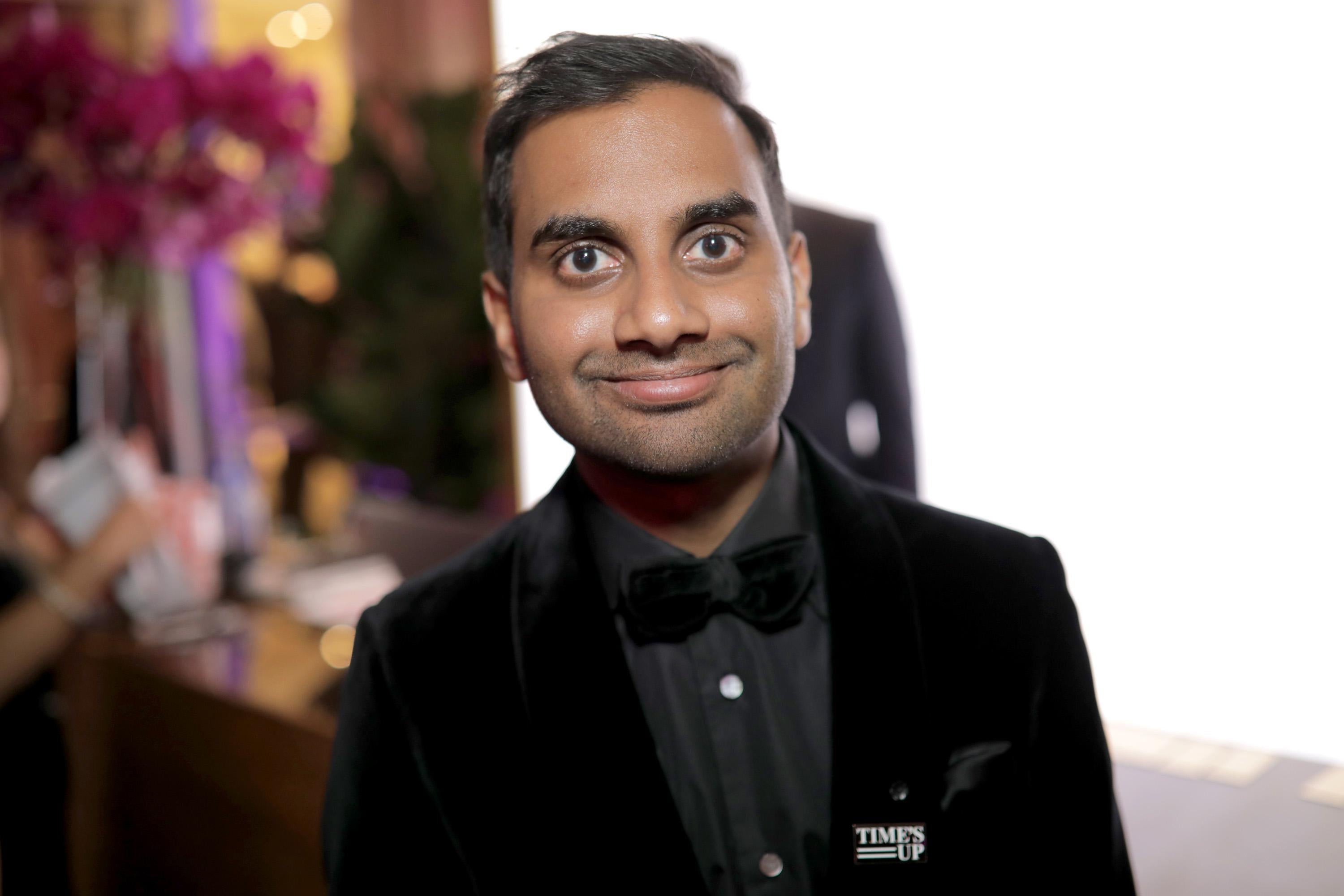 Aziz Ansari wears a Time's Up pin.