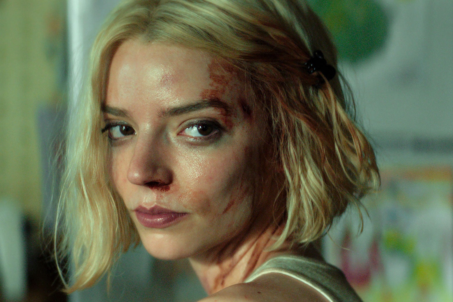 A short-haired blonde woman with a bruised face.