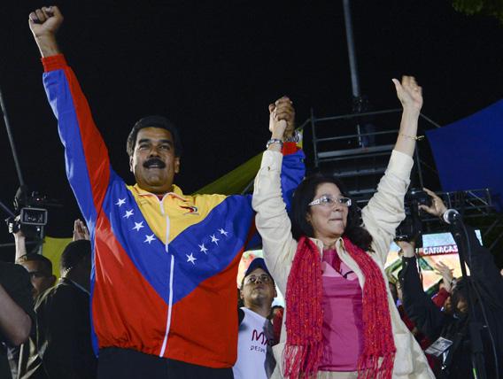 Venezuelan President elect Nicolas Maduro (L) celebrates with his wife Cilia Flores after knowing the election results in Caracas on April 14, 2013.