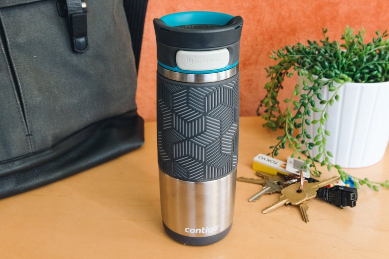 The Contigo mug beside keys and a plant