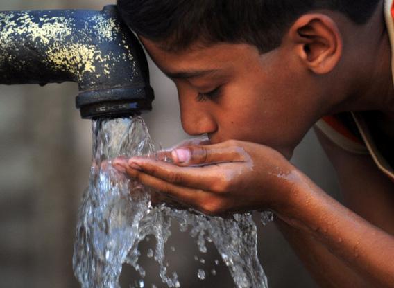 A Pakistani child drinks water from a hand-pump water fountain on March 22, 2011, on World Water Day.