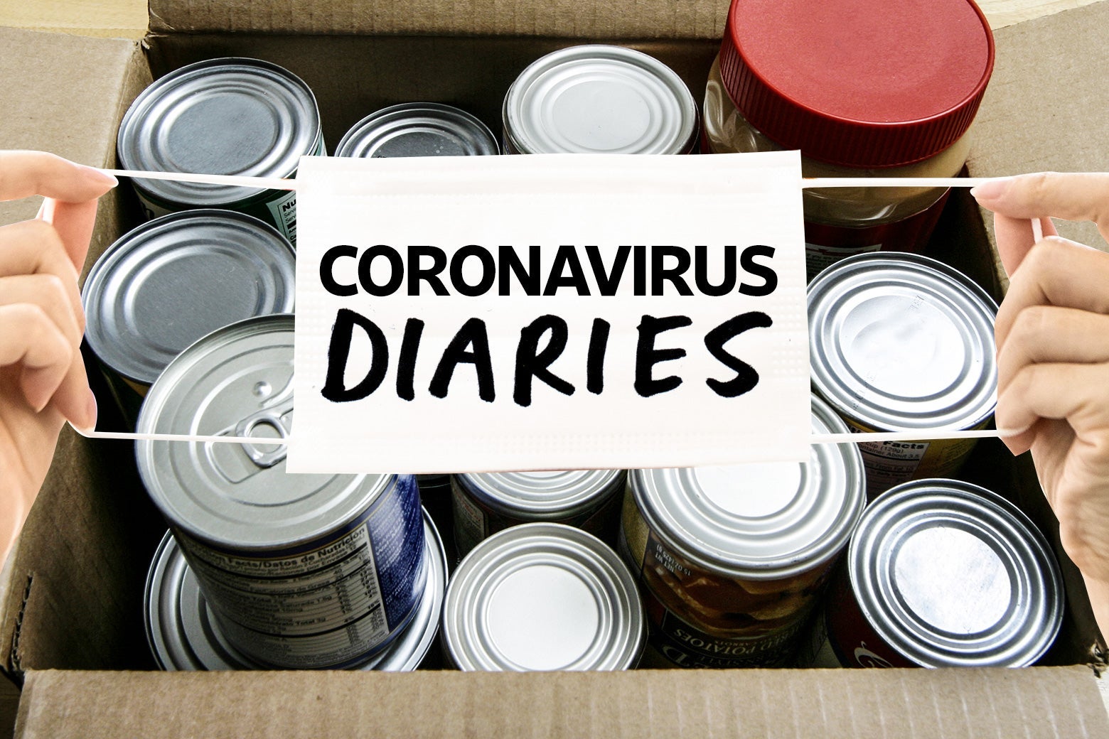 A mask labeled "coronavirus diaries" is held up over a cardboard box filled with cans.