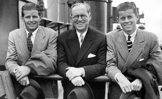 John Fitzgerald Kennedy, right, and his brother Robert, left, surround their father, Joseph
