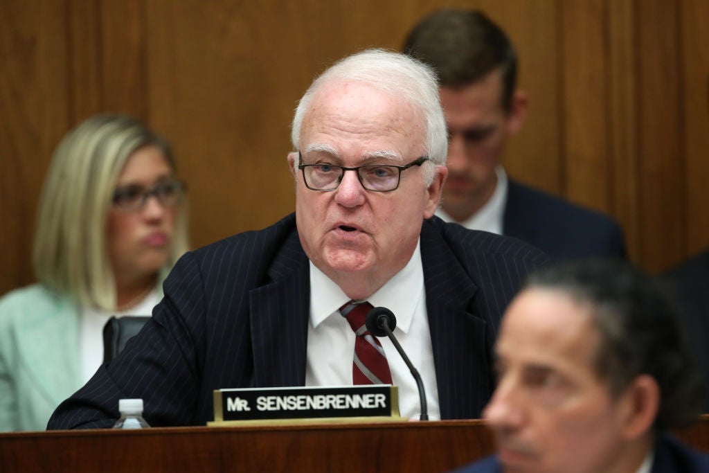 Sensenbrenner, seated, speaks into a microphone.