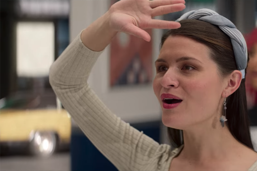 Phillipa Soo stands singing with her arm over her forehead looking off camera.