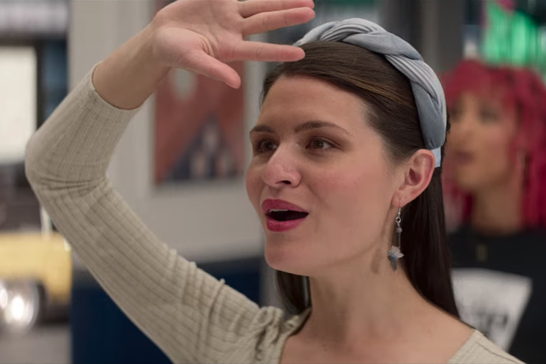 Phillipa Soo stands singing with her arm over her forehead looking off camera.