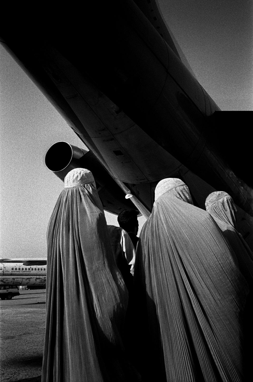 Kabul. Afghanistan. November 2002Women line up to board an Ariana Airlines flight at Kabul Airport