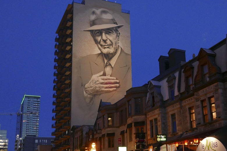 The mural of the late Canadian singer-songwriter Leonard Cohen, inaugurated in November 2017 over a Montreal street, now lit up every night, is viewed on June 23, 2019 on Crescent Street in Montreal.
