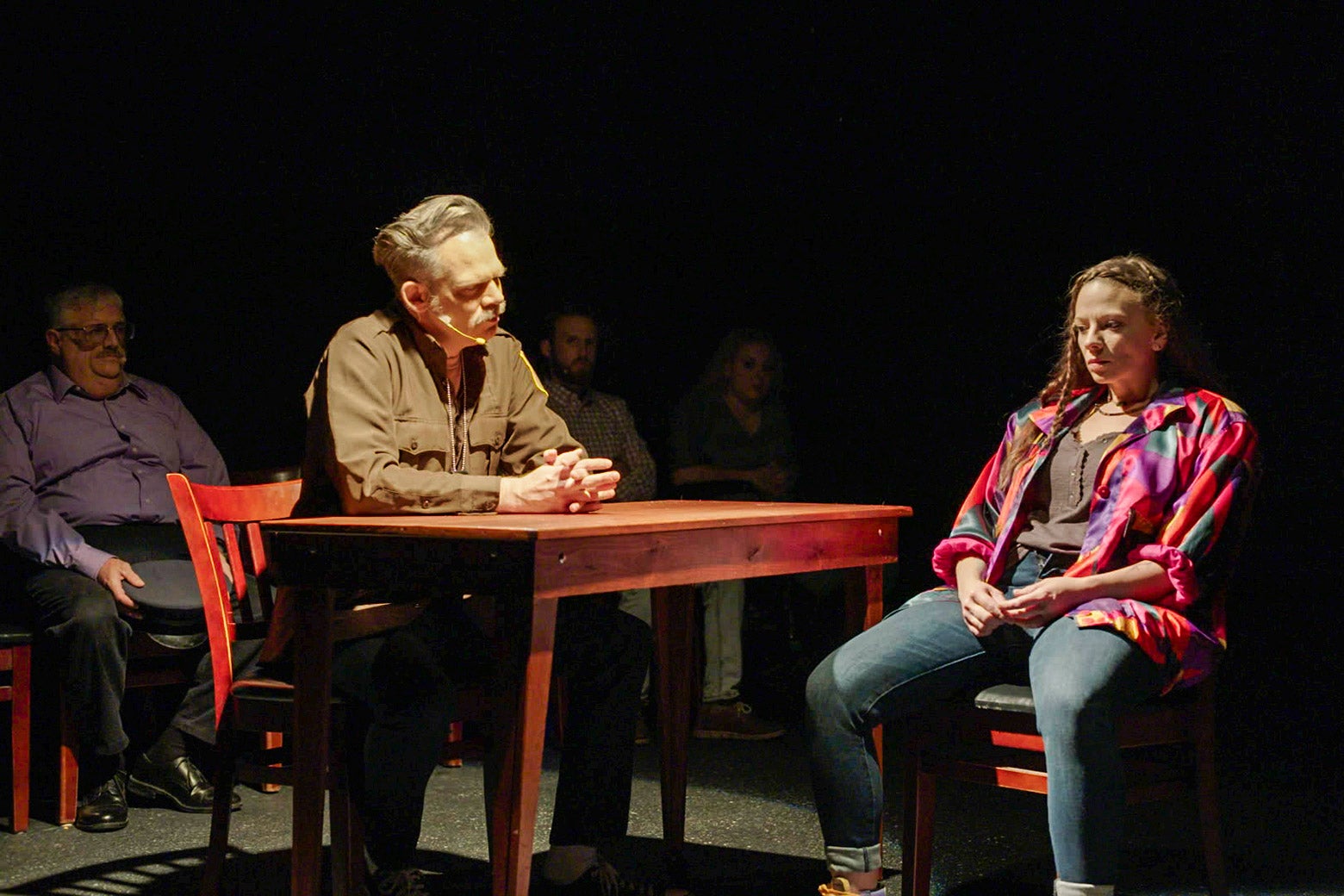 A man and a woman sit together at a table.