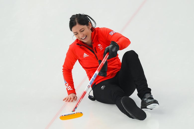 Curler smiling, butt on ice