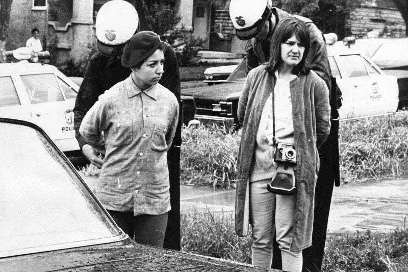 Police handcuff two young women in front of Belmont High School during a protest at the school on March 8, 1968, in Los Angeles.