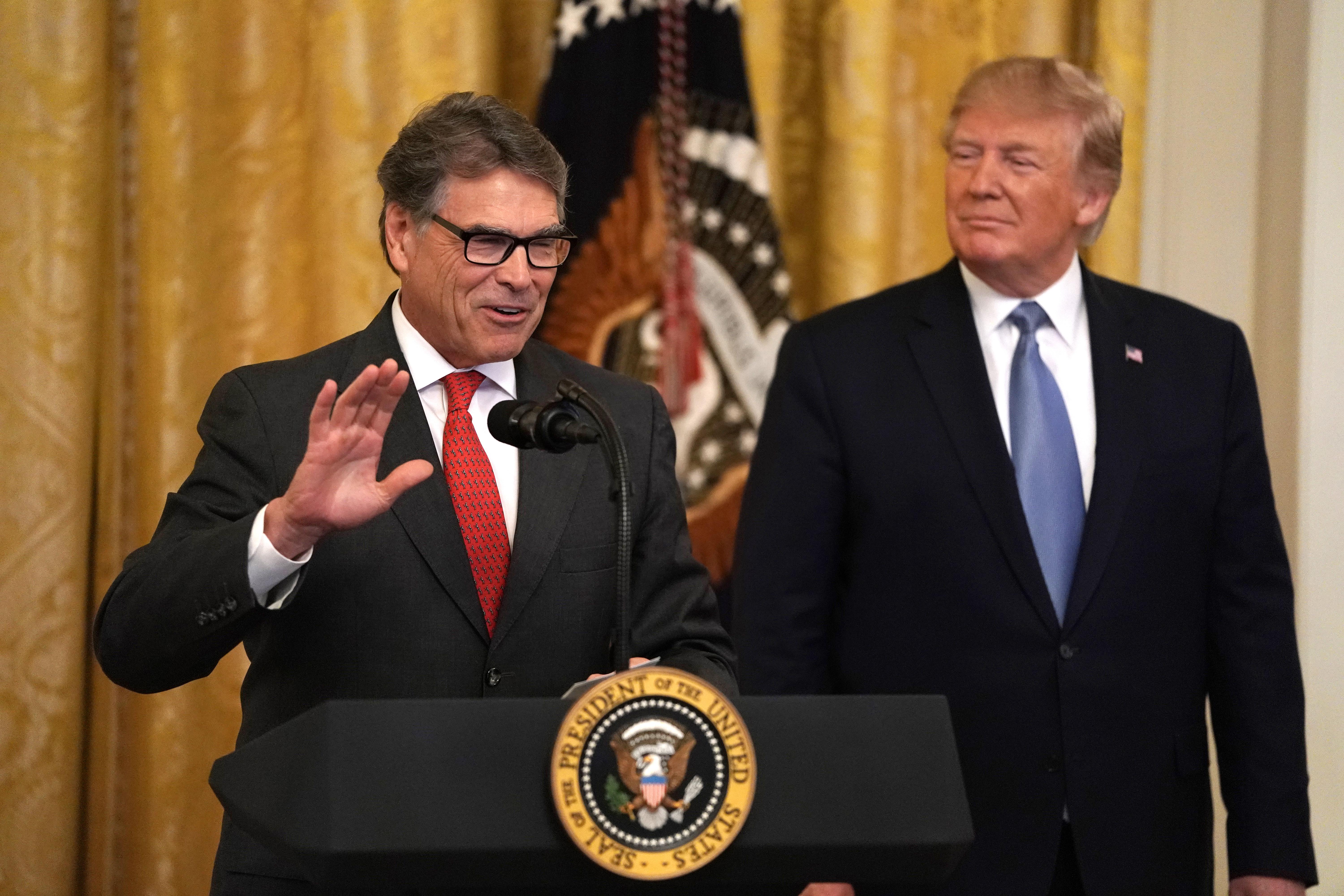 Energy Secretary Rick Perry speaks as President Donald Trump looks on at the White House on July 7, 2019.