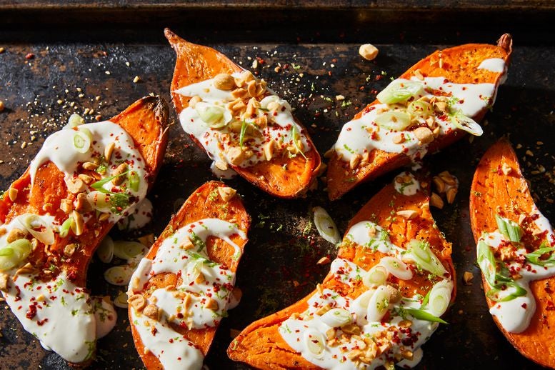 Six roasted sweet potato halves drizzled with maple crème fraîche dressing, scallions, peanuts, chile flakes, and lime zest.
