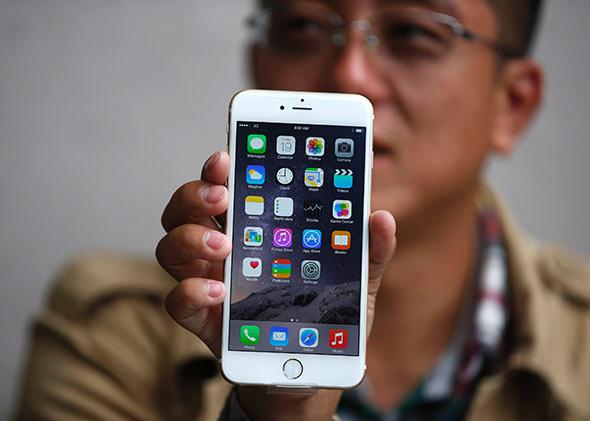 Tony Zhan holds his iPhone 6 Plus. 