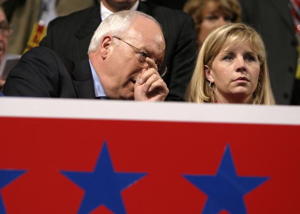 Dick Cheney whispers in Liz Cheney's ear.