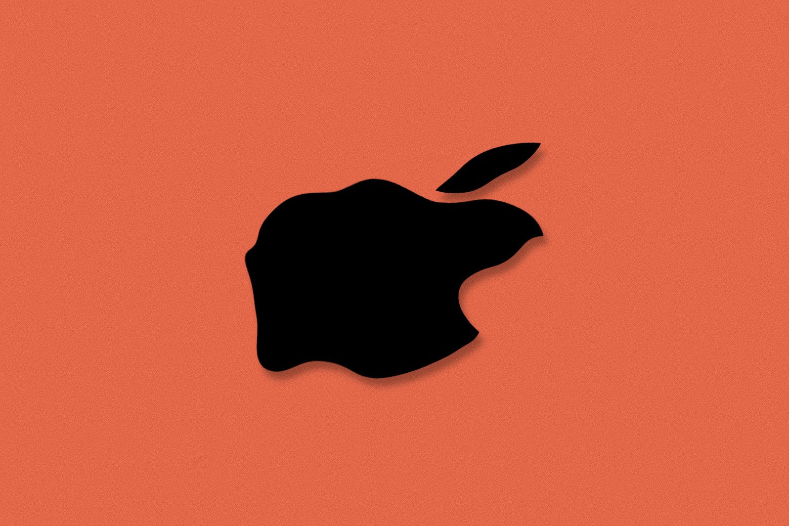 The Apple logo, looking rotted and lying flat on a red floor